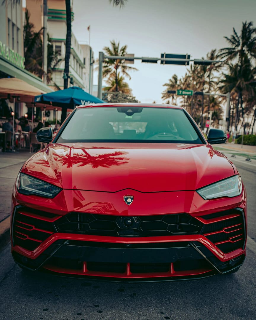 Front view of a red Lamborghini Urus on a city street